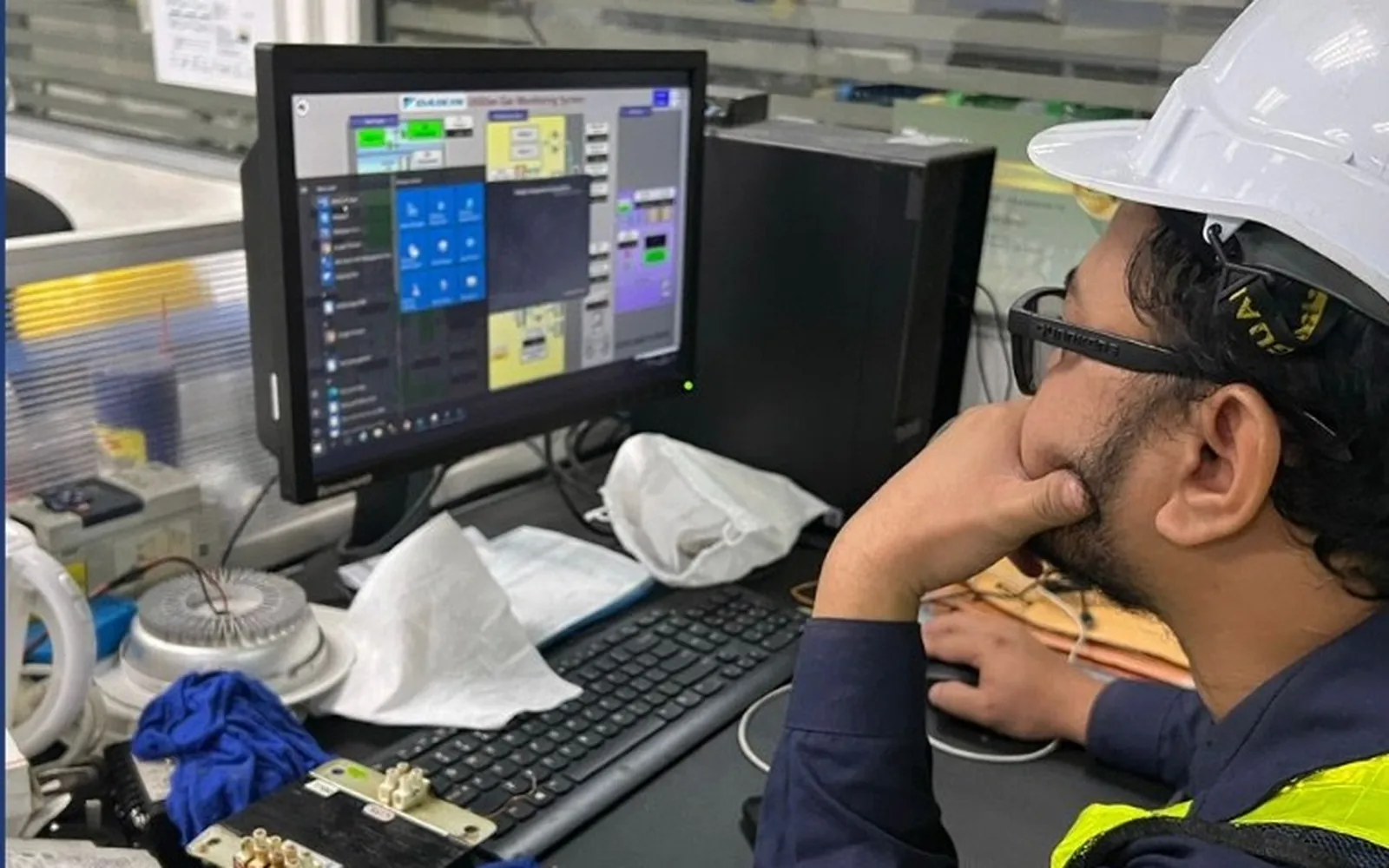 HAZS reliability engineer reviewing plant asset data on a monitoring workstation